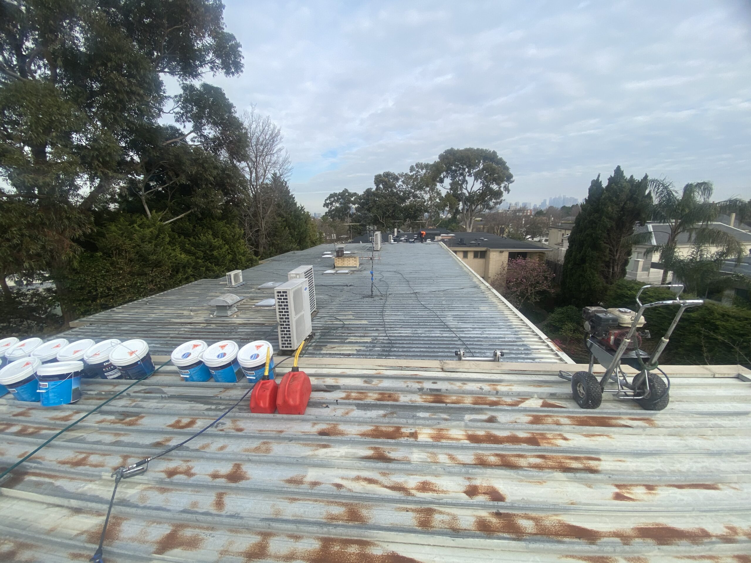 Weathered metal roof with visible rust patches before restoration in Toorak