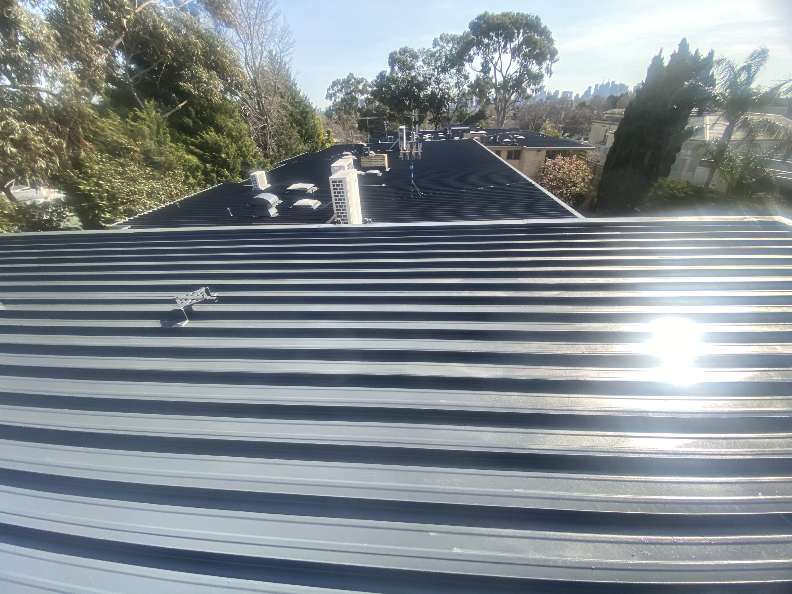 Restored metal roof in Toorak viewed across adjoining roof sections